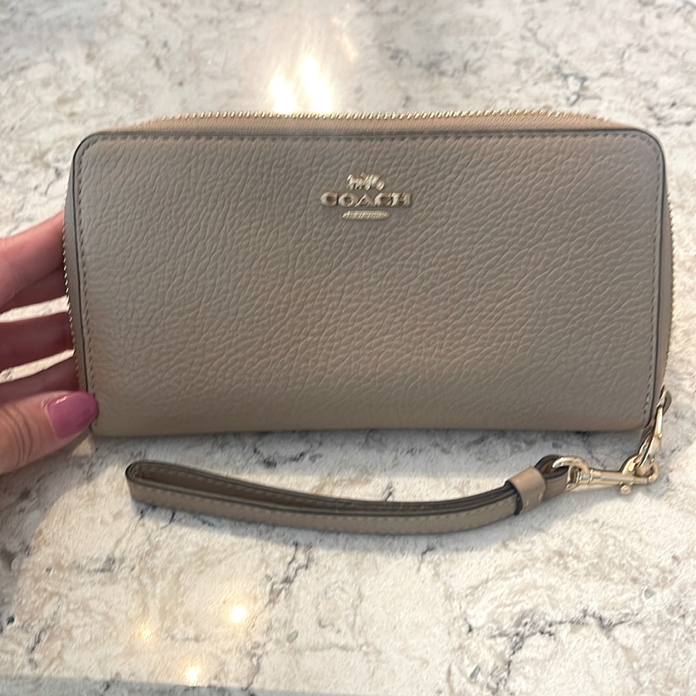 Slightly used Coach wallet with wrist strap.